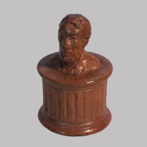 15-25010, PA Redware pottery penny bank profile of Abe Lincoln, inscribed. $8,500